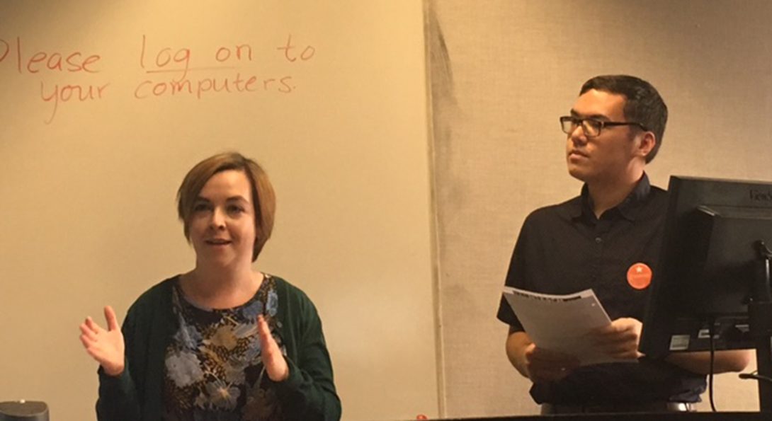 Koxholt and Fitzpatrick present in front of a whiteboard