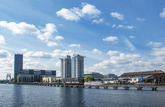 The Spree River with the Molecule Man statue visible in the distance.