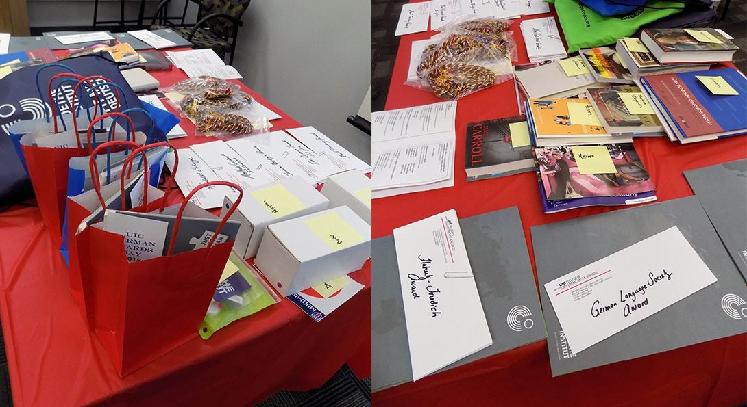 Gift bags, envelopes, boxes, and books on display as German Awards Day prizes.