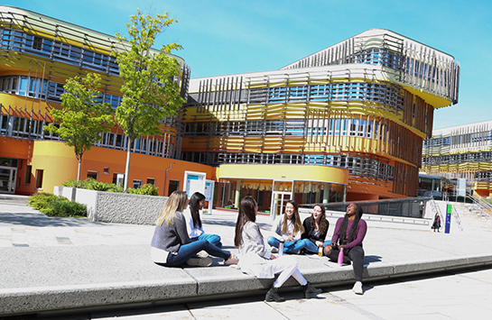 students sitting in front of the Vienna campus
